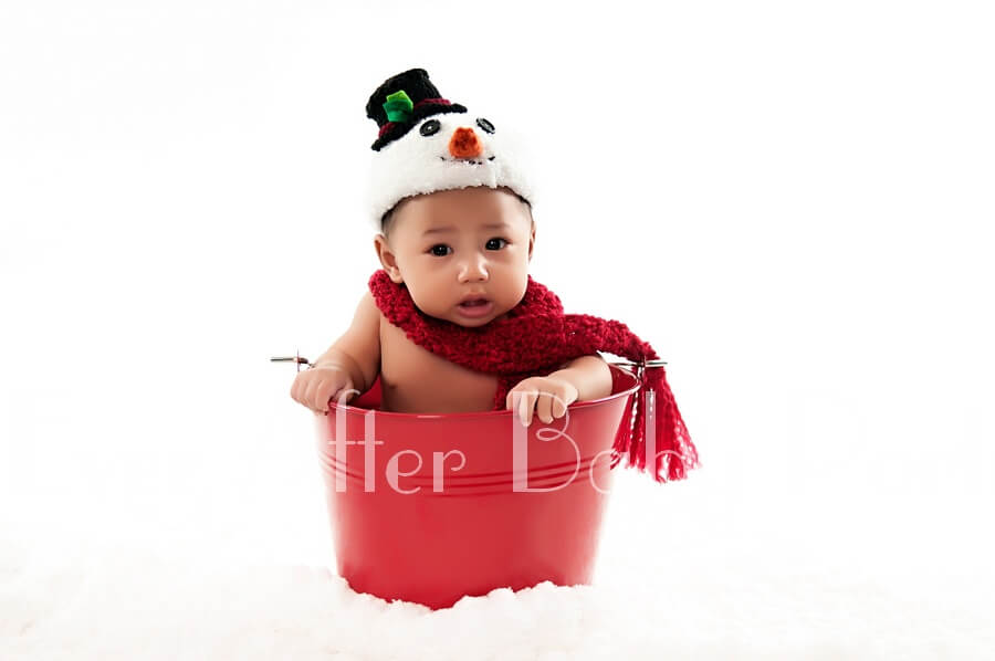 Baby boy in red bucket.