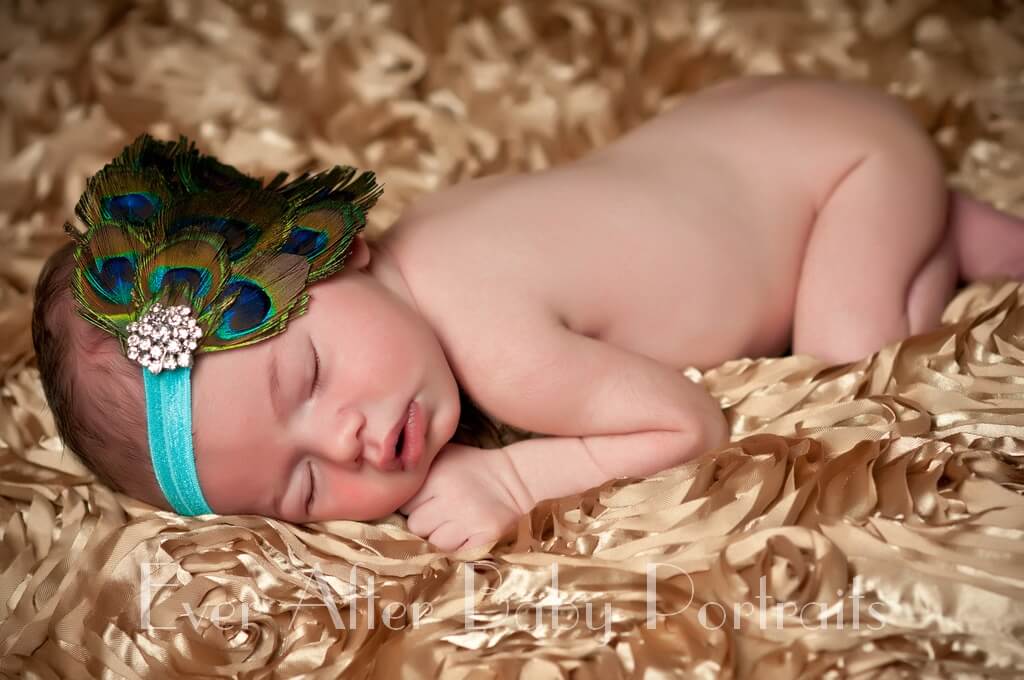 Newborn Baby Portrait on Gold with peacock feather