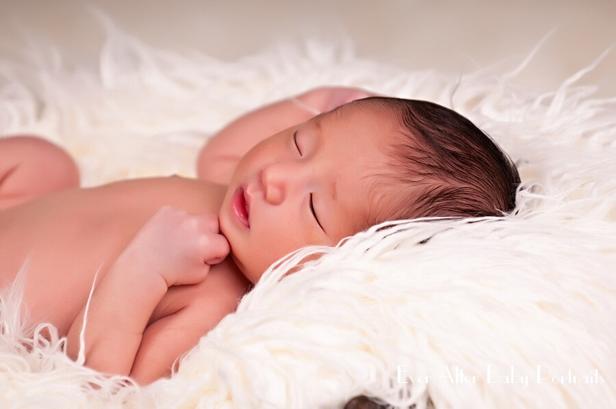 Newborn on white blanket